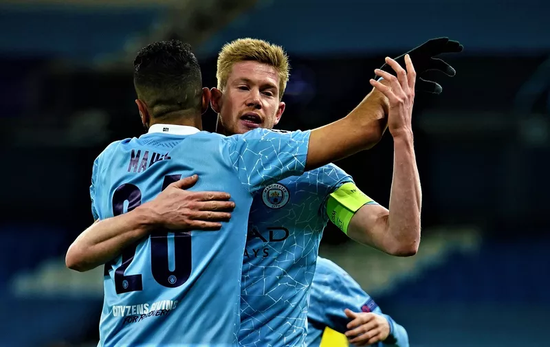 Manchester City's Kevin De Bruyne, right, celebrates with Riyad Mahrez after scoring his side's first goal during the Champions League, first leg, quarterfinal soccer match between Manchester City and Borussia Dortmund at the Etihad stadium in Manchester, Tuesday, April 6, 2021. (AP Photo/Dave Thompson)
