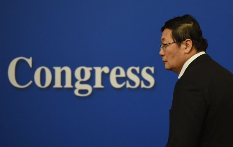 Chinese Finance Minister Lou Jiwei arrives for a National People's Congress press conference in Beijing on March 7, 2016. 
China's labour contract law harms workers and must become more flexible, Lou said on March 7, as China seeks to transform the structure of its economy while maintaining  employment.  / AFP PHOTO / GREG BAKER