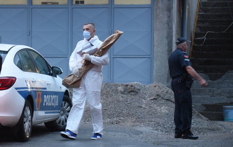 Forensics personnel operate near the scene of a shooting in Cetinje, in Montenegro, on August 12, 2022. - At least 11 people were killed during a mass shooting in Montenegro's central city of Cetinje on Friday, the country's public broadcaster said. (Photo by SAVO PRELEVIC / AFP)