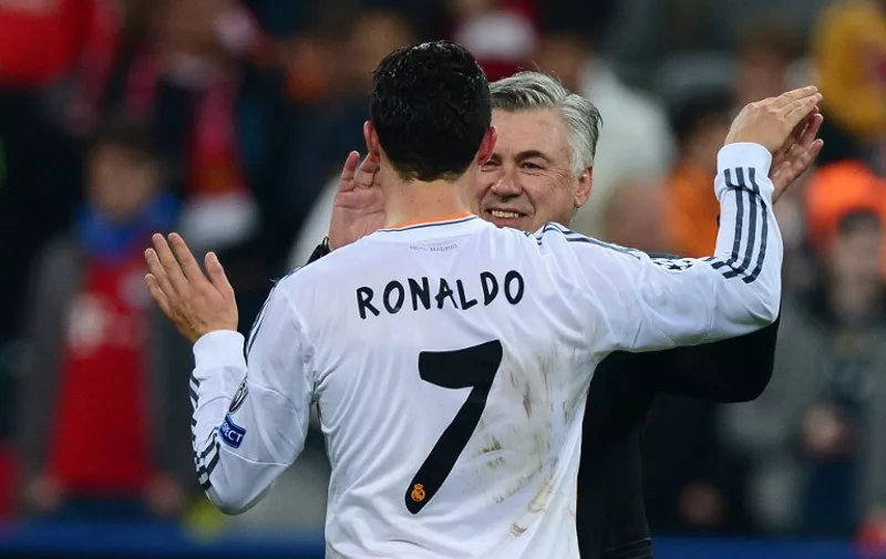 Real Madrid's Italian coach Carlo Ancelotti (R) and Real Madrid's Portuguese forward Cristiano Ronaldo celebrate after the UEFA Champions League second-leg semi-final football match FC Bayern Munich vs Real Madrid CF in Munich, southern Germany, on April 29, 2014. Real Madrid won the match 0-4 to secure their place in the final. AFP PHOTO / JOHN MACDOUGALL