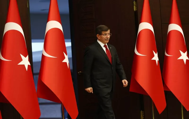 Turkish Prime Minister Ahmet Davutoglu arrives for a news conference following his meeting with President Tayyip Erdogan in Ankara on November 24, 2015. Ahmet Davutoglu today announced a new cabinet stacked with loyal allies of President Recep Tayyip Erdogan, including his son-in-law Berat Albayrak who was named energy minister. Another longstanding Erdogan ally, Binali Yildirim, was named transport minister but there was no space in the cabinet for former deputy premier Ali Babacan, a trusted figure in global financial markets.  AFP PHOTO / ADEM ALTAN / AFP / ADEM ALTAN
