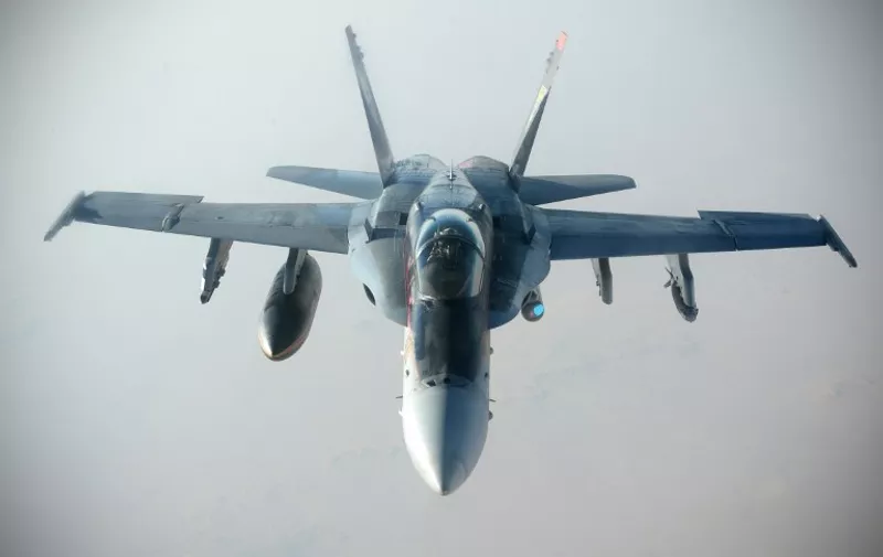 This October 4, 2014 US Navy handout image shows a US Navy F-18E Super Hornet supporting operations against IS, after being refueled by a KC-135 Statotanker over Iraq after conducting an airstrike.  The US military unleashed a wave of air strikes against Islamic State jihadists in Syria and Iraq this weekend, destroying tanks, armored vehicles and mortar teams, a statement said October 5. AFP PHOTO / HANDOUT / US AIR FORCE / Staff Sgt. Shawn Nickel    RELEASED         == RESTRICTED TO EDITORIAL USE / MANDATORY CREDIT: "AFP PHOTO / HANDOUT / US Air Force / Staff Sgt. Shawn Nickel  "/ NO MARKETING / NO ADVERTISING CAMPAIGNS / NO A LA CARTE SALES / DISTRIBUTED AS A SERVICE TO CLIENTS ==