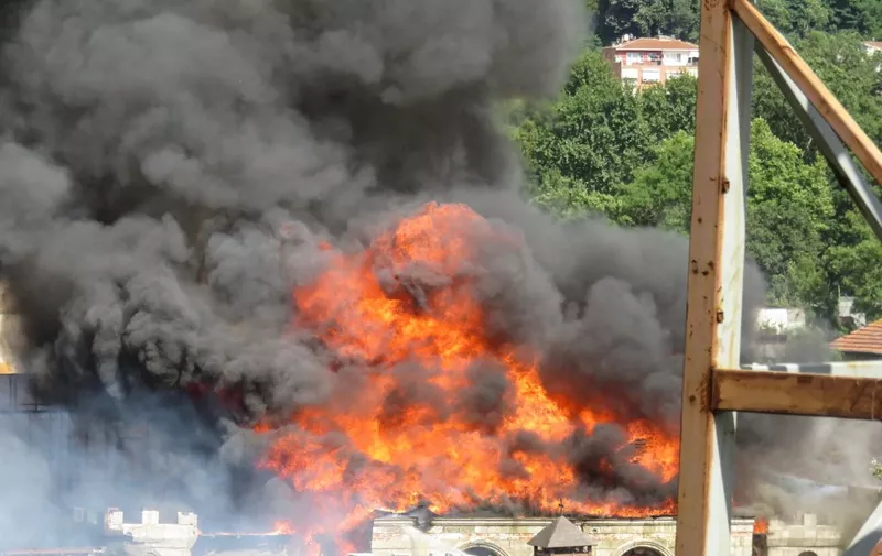 Flames are rising from a celebrated outdoor film set situated on the Asian side of Istanbul, on June 29, 2018. An outdoor film set, used in a number of top-rating Turkish soap dramas, caught fire on June 29, but there were no casualties, local officials said. (Photo by Handout / DOGAN NEWS AGENCY / AFP) / Turkey OUT