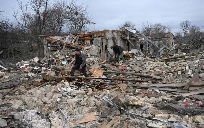 People search the rubble of a house following a Russian strike in the village of Velyka Vilshanytsia, some 50km from Lviv, on March 9, 2023. - The largest Russian strikes on Ukraine in weeks killed at least six people and caused power outages across the war-battered nation on March 9. Kyiv's military downed nearly half of the missiles launched by Russia over at least 10 regions, as the fight raged on for control of the symbolic prize Bakhmut in Ukraine's east. (Photo by YURIY DYACHYSHYN / AFP)