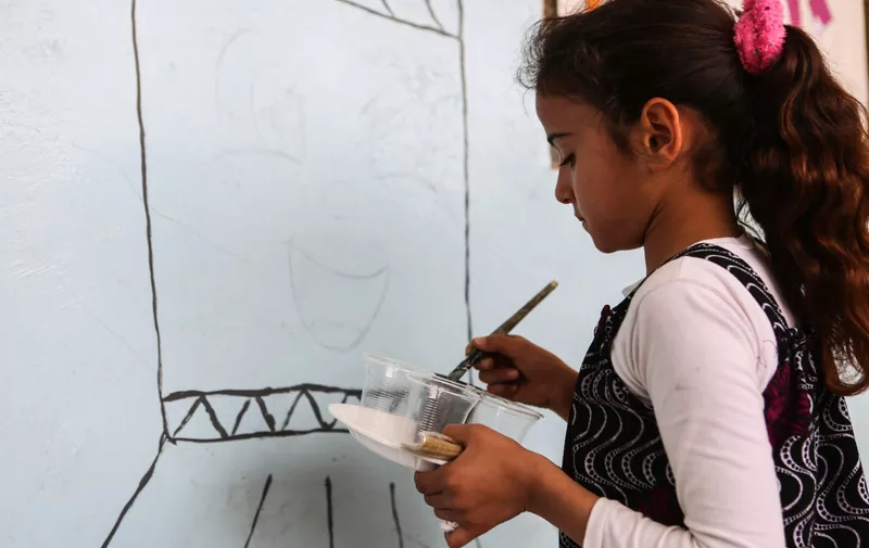 April 15, 2019 - Sarmada, Syria, 15 th April 2019. Children in the northern Syrian village of Kafr Dariyan draw and paint in their class on the occasion of World Art Day. Being able to attend school is far from being guaranteed in Syria, where the eight years of conflict have seriously damaged and destroyed essential education infrastructures in the country, with many children missing years of their education and currently out of school. Several children have faced terrible traumas in addition to living without adequate shelter, food, water and sanitary services, and health care. School lessons aim not just at providing education but also at helping children coping with the chronic stress accumulated as a result of the violence, loss and instability they experienced. The village of Kafr Dariyan is located in the Idlib governorate, close to the Syrian town of Sarmada and the border with Turkey,Image: 426537251, License: Rights-managed, Restrictions: , Model Release: no