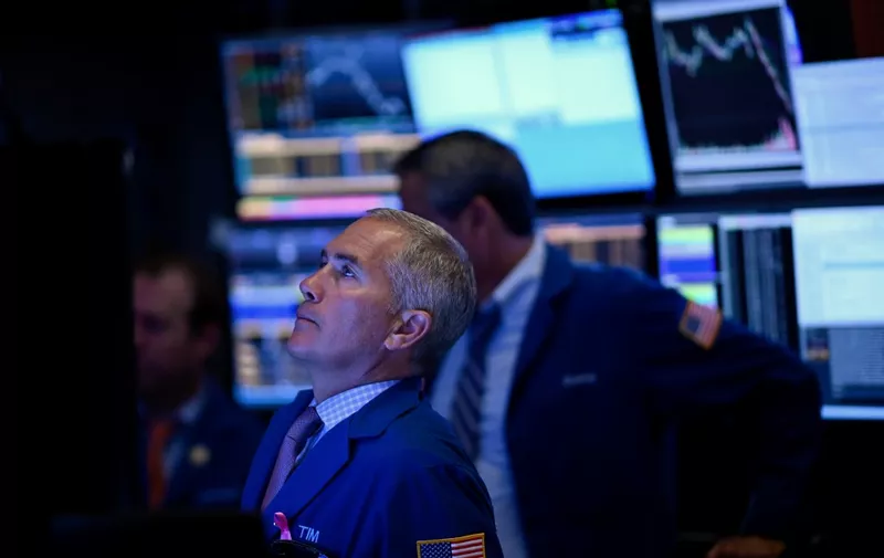Traders work during the opening bell at the New York Stock Exchange (NYSE) on October 2, 2019 at Wall Street in New York City. - US stocks continued to fall at the markets' open on Wednesday, as disappointing employment data added to the gloom from a dismal manufacturing report on Tuesday.Tuesday's losses wiped out gains won in the third quarter by the benchmark Dow and S&amp;P 500, and the downward slide continued. (Photo by Johannes EISELE / AFP)
