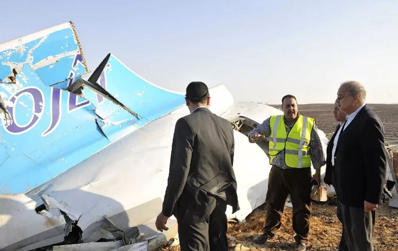 A handout picture released by Egypt's Prime Minister's office on October 31, 2015, shows PM Sherif Ismail (R) at the site of the wreckage of a crashed A321 Russian airliner in Wadi al-Zolomat in Hassana province, a mountainous area of Egypt's Sinai Peninsula. The Airbus A321, flight 9268, with 214 Russian and three Ukrainian passengers and seven crew, had taken off from the Red Sea resort of Sharm el-Sheikh in south Sinai bound for Saint Petersburg, it lost contact with air traffic control 23 minutes later , crashing in Egypt's Sinai Peninsula killing everyone on board. AFP PHOTO / HO / SELIMAN AL-OTEIFI / EGYPTIAN PRIME MINISTER'S OFFICE
=== RESTRICTED TO EDITORIAL USE - MANDATORY CREDIT "AFP PHOTO / HO / EGYPTIAN PRIME MINISTER'S OFFICE" - NO MARKETING NO ADVERTISING CAMPAIGNS - DISTRIBUTED AS A SERVICE TO CLIENTS ===