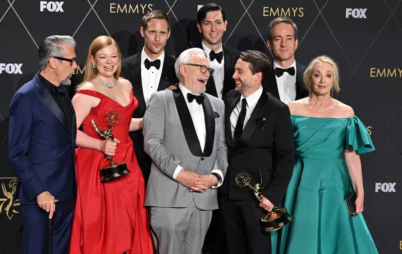 Cast members from "Succesion" (from L) US actor Alan Ruck, Australian actress Sarah Snook, Swedish actor Alexander Skarsgard, Scottish actor Brian Cox, US actor Nicholas Braun, US actor Kieran Culkin, British actor Matthew Macfadyen and US actress J. Smith-Cameron pose in the press room with the award for Outstanding Drama Series during the 75th Emmy Awards at the Peacock Theatre at L.A. Live in Los Angeles on January 15, 2024. (Photo by Robyn BECK / AFP)