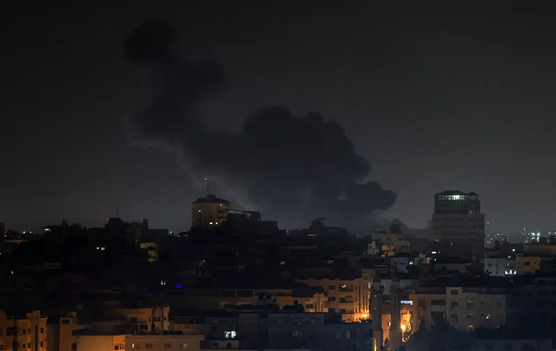 Smoke rises above buildings in Gaza City as Israel launched air strikes on the Palestinian enclave early on February 2, 2023. - Israel conducted air strikes on the central Gaza Strip hours after intercepting a rocket fired from the Palestinian territory, according to AFP journalists and witnesses on February 2, 2023. (Photo by MOHAMMED ABED / AFP)