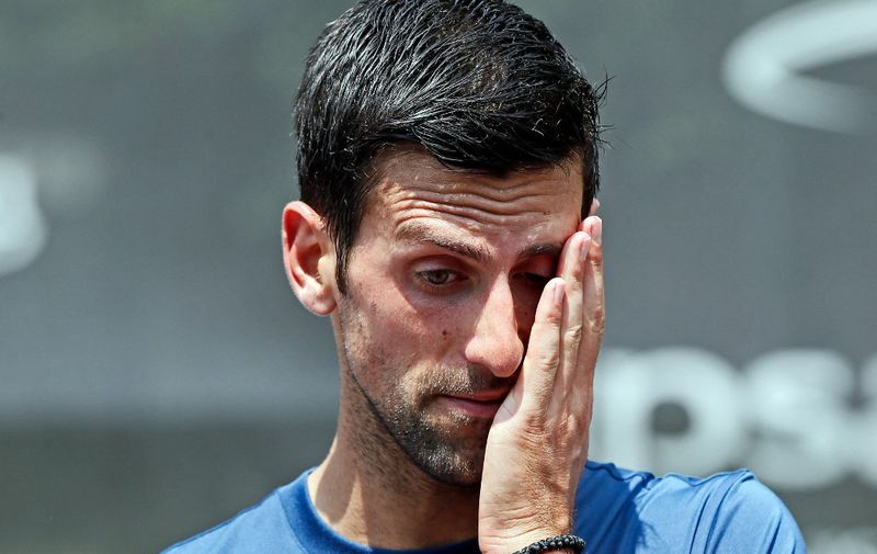 Serbian tennis player Novak Djokovic reacts as he speaks to the media during an open training session in Belgrade, in his native Serbia on June 19, 2019, ahead of the Wimbledon tennis tournament. - Djokovic leads the men's ATP tennis rankings released on June 17, 2019, ahead of French Open champion Rafael Nadal and former world number one Roger Federer. (Photo by Pedja MILOSAVLJEVIC / AFP)