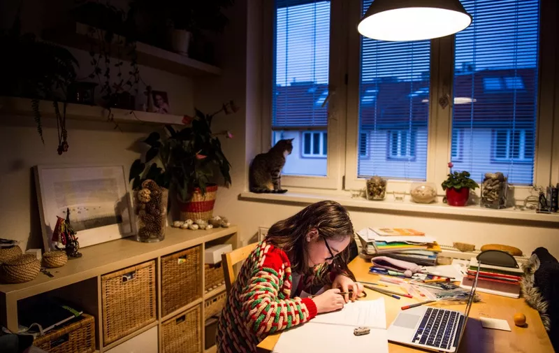 Jana(11) does her homework at her home during the lockdown of schools caused by the spread of the new coronavirus COVID-19 in Bratislava on March 27, 2020. - The newly-appointed government of new PM Igor Matovic came up with a new set of precautionary measures against the spread of the new coronavirus as obligatory face masks, specific shopping hours for elders and continuation of lockdown of schools. Slovakia has 269 positively tested cases of Covid 19. (Photo by VLADIMIR SIMICEK / AFP)