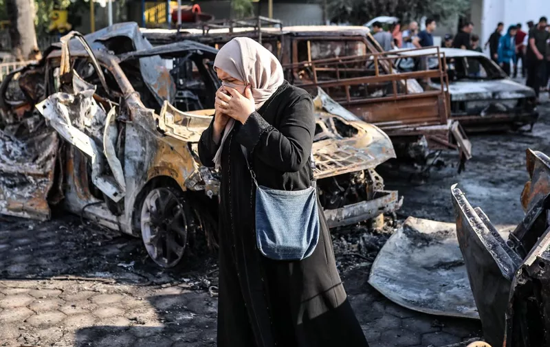 GAZA CITY, GAZA - OCTOBER 18: A woman is seen amid wreckage of vehicles after Al-Ahli Baptist Hospital was hit in Gaza City, Gaza on October 18, 2023. According to the Palestinian authorities, Israeli army is responsible for the deadly bombing. While the number of deaths as a result of the attack on the hospital increased to 471, major damage occurred in the hospital building and its surroundings. Belal Khaled / Anadolu (Photo by Belal Khaled / ANADOLU / Anadolu via AFP)