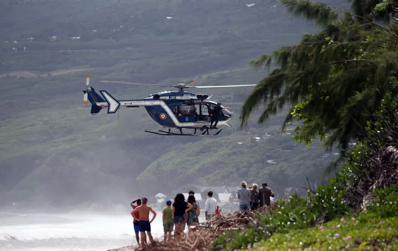 Rescuers and gendarmes arrive by helicopter to rescue young bodyboarder, who died following an attack by a shark, on April 29, 2017 in Saint-Leu, on the French indian ocean island of La Reunion. (Photo by Richard BOUHET / AFP)