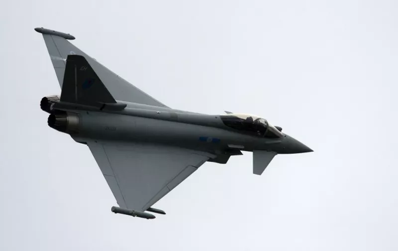 A Eurofighter Typhoon, a twin-engine multi role fighter during a flying display at the Farnborough International Airshow in Hampshire, southern England, on July 12, 2012. AFP PHOTO / ADRIAN DENNIS