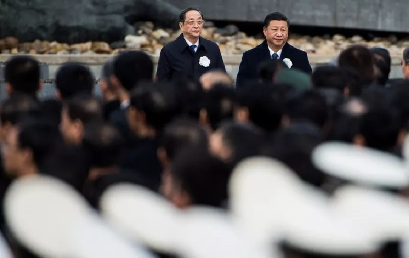 Chinese President Xi Jinping (R) attends a memorial ceremony at the Nanjing Massacre Memorial Hall on the second annual national day of remembrance to commemorate the 80th anniversary of the massacre in Nanjing on December 13, 2017. 
Sirens blared and thousands of doves were released as Chinese President Xi Jinping presided over a sombre ceremony in Nanjing marking 80 years since the wartime massacre in the city by Japanese troops. / AFP PHOTO / CHANDAN KHANNA