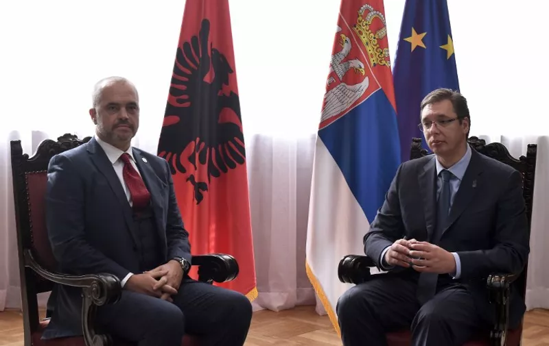 Albanian Prime Minister Edi Rama (L) and his Serbian counterpart Aleksandar Vucic (R) pose for a picture prior to their meeting in Belgrade on November 10, 2014. Rama arrived on Monday as the first Albanian prime minister visiting Serbia in 68 years, amid tensions risen over recent football incidents showing the fragility of region's stability.  AFP PHOTO / ANDREJ ISAKOVIC