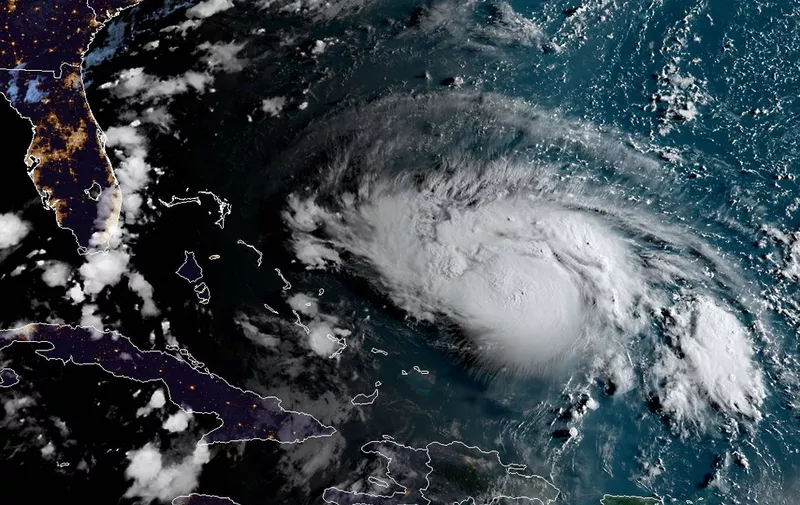 This satellite image obtained from NOAA/RAMMB, shows Hurricane Dorian as it approaches the Bahamas and Florida at 11:20UTC on August 30, 2019. - Dorian on Friday was on track to become a major hurricane with a dangerous storm surge and potential for life-threatening flash floods. Its maximum sustained winds have reached 105mph (165kph), making it a Category 2 hurricane, the National Hurricane Center said. (Photo by HO / NOAA/RAMMB / AFP) / RESTRICTED TO EDITORIAL USE - MANDATORY CREDIT "AFP PHOTO / NOAA/RAMMB/HANDOUT" - NO MARKETING - NO ADVERTISING CAMPAIGNS - DISTRIBUTED AS A SERVICE TO CLIENTS / The erroneous mention[s] appearing in the metadata of this photo has been modified in AFP systems in the following manner: the byline should rear [HO (HANDOUT)] instead of [Jose ROMERO]. Please immediately remove the erroneous mention[s] from all your online services and delete it (them) from your servers. If you have been authorized by AFP to distribute it (them) to third parties, please ensure that the same actions are carried out by them. Failure to promptly comply with these instructions will entail liability on your part for any continued or post notification usage. Therefore we thank you very much for all your attention and prompt action. We are sorry for the inconvenience this notification may cause and remain at your disposal for any further information you may require.
