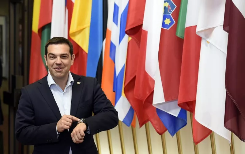 Greek Prime Minister Alexis Tsipras leaves following a meeting with French President  Francois Hollande and German Chancellor Angela Merkel on the sidelines of an EU-Latin American summit at EU headquarter, June 10, 2015 in Brussels.      AFP PHOTO / ALAIN JOCARD