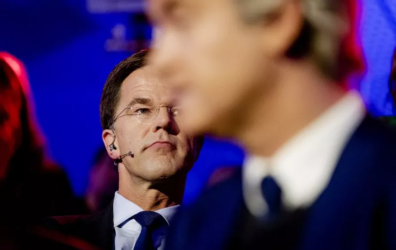 Geert Wilders of the Freedom Party (PVV) (R) and Dutch Prime Minister and People's Party for Freedom and Democracy (VVD) candidate Mark Rutte look on prior to a televised debate between the eight top party leaders in The Hague on March 14, 2017, a day before the parliamentary elections. / AFP PHOTO / ANP / Robin van Lonkhuijsen / Netherlands OUT