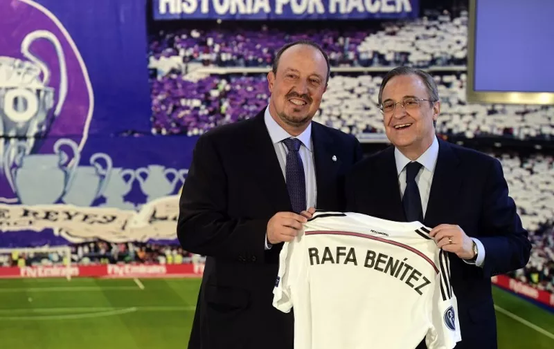 The new head-coach of Real Madrid football team, Rafael Benitez (L) and Real Madrid's president Florentino Perez smile as they pose with the team's jersey during a press conference at the Santiago Bernabeu stadium in Madrid on June 3, 2015. The hiring of Rafael Benitez as Real Madrid boss today makes the Spaniard the 10th coach to serve under Florentino Perez during his two spells as the club's president between June 2000-February 2006 and since June 2009. 