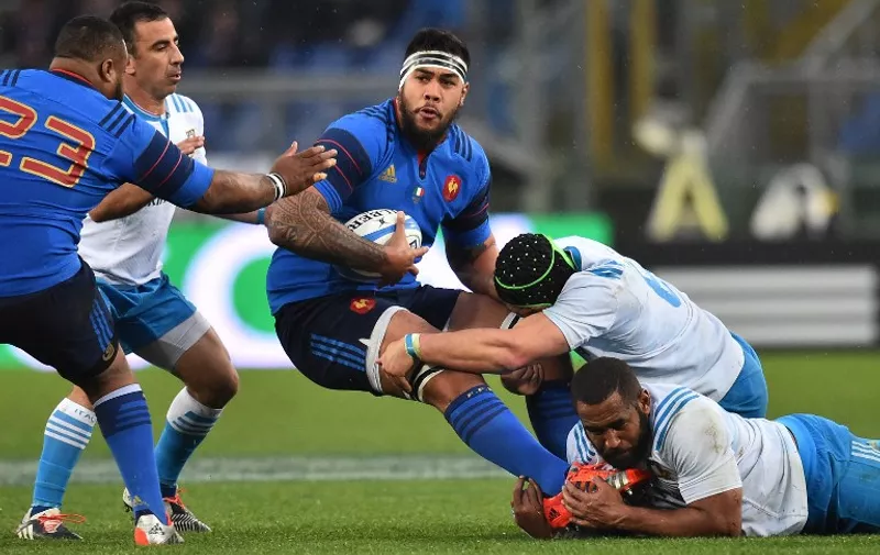 France's lock Romain Taofifenua (C) is tackled by Italian players during the Six Nations international rugby union match between Italy and France on March 15, 2015 at the Olympic Stadium in Rome.     AFP PHOTO / GABRIEL BOUYS