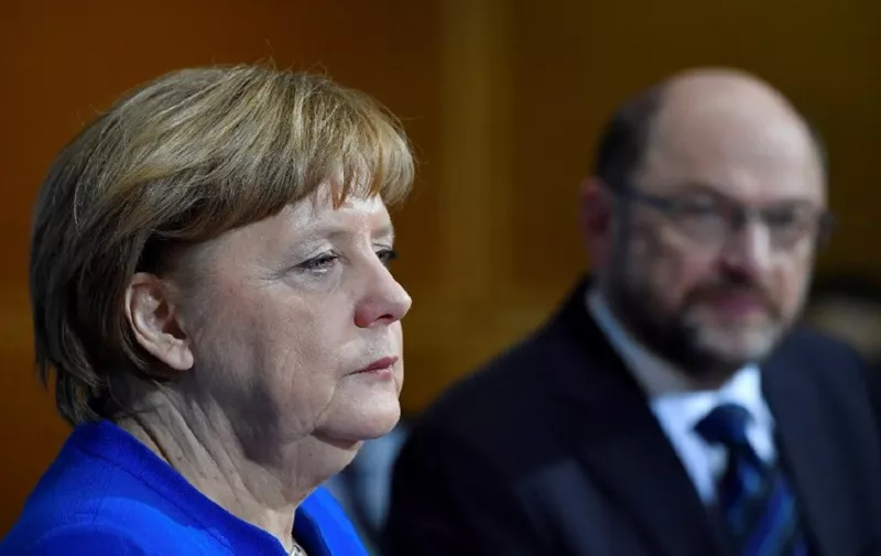 German Chancellor Angela Merkel (CDU) listens during a joint press conference with the leader of the Social Democratic Party (SPD) Martin Schulz (R) and the leader of the Christian Social Union (CSU) after talks to form a new government on January 12, 2018 at the SPD headquarters in Berlin.
German Chancellor Angela Merkel's conservatives reached a "breakthrough" deal with the country's second biggest party, the Social Democrats, toward building a new coalition government, sources close to the negotiations said. / AFP PHOTO / John MACDOUGALL