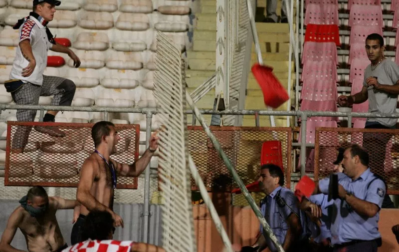 Fans of Croatia fight with policemen at the end of the match against Malta for the German 2006 World Cup at the Ta Qali stadium in Valletta, 07 September 2005. The match ended 1-1.  AFP PHOTO / PACO SERINELLI