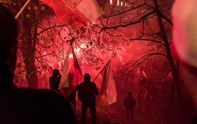 WARSAW, POLAND - NOVEMBER 11, 2017: The annual march of Poland's National Independence Day  which commemorates the anniversary of the Restoration of a Polish State in 1918. Thousands of nationalists burn flares and wave Polish flags under the slogan 'we want God'., Image: 355361138, License: Rights-managed, Restrictions: , Model Release: no, Credit line: Profimedia, Alamy
