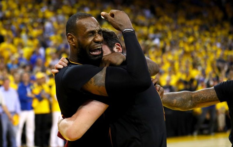 OAKLAND, CA - JUNE 19: LeBron James #23 and Kevin Love #0 of the Cleveland Cavaliers celebrate after defeating the Golden State Warriors 93-89 in Game 7 of the 2016 NBA Finals at ORACLE Arena on June 19, 2016 in Oakland, California. NOTE TO USER: User expressly acknowledges and agrees that, by downloading and or using this photograph, User is consenting to the terms and conditions of the Getty Images License Agreement.   Ezra Shaw/Getty Images/AFP