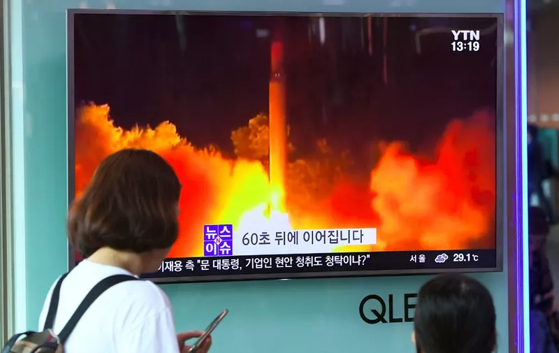 People watch a television screen showing a video footage of North Korea's latest test launch of an intercontinental ballistic missile (ICBM), at a railway station in Seoul on July 29, 2017. - North Korean leader Kim Jong-Un said on July 29 the country's second ICBM test demonstrated the ability to strike any target in the United States, in a direct challenge to President Donald Trump who had issued dire warnings over its missile program. (Photo by JUNG Yeon-Je / AFP)