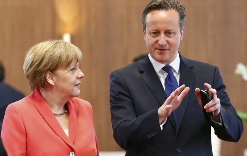 German Chancellor Angela Merkel (L) chats with British Prime Minister David Cameron prior to the second working session of a G7 summit at the Elmau Castle near Garmisch-Partenkirchen, southern Germany, on June 8, 2015. Germany hosts a G7 summit at the Elmau Castle on June 7 and June 8, 2015. AFP PHOTO / POOL / MICHAELA REHLE