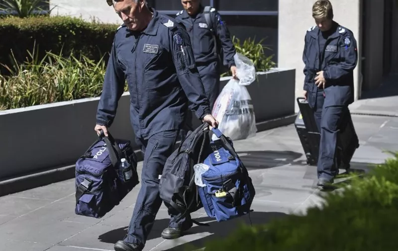 Victoria Police forensic officers remove a bag from the Italian consulate in Melbourne on January 9, 2019. - Australian police are investigating the delivery of suspicious packages sent to foreign embassies and consulates in Melbourne and Canberra, police and embassy sources told AFP on January 9. (Photo by William WEST / AFP)