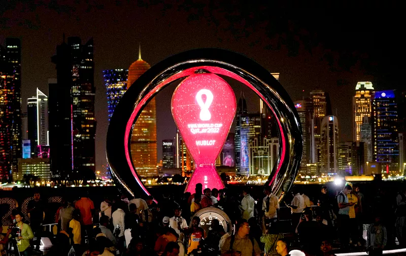 People gather around the official countdown clock showing remaining time until the kick-off of the World Cup 2022 in Doha, Qatar, Thursday, Nov. 17, 2022. Final preparations are being made for the soccer World Cup which starts on Nov. 20 when Qatar face Ecuador. (AP Photo/Hassan Ammar)