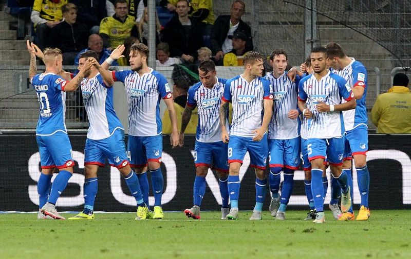 Hoffenheim's players celebrate Hoffenheim's midfielder Sebastian Rudy scoring the 1-0 during the German first division Bundesliga football match TSG 1899 Hoffenheim vs Borussia Dortmund in Sinsheim, on September 23, 2015.    AFP PHOTO / DANIEL ROLAND

RESTRICTIONS: DURING MATCH TIME: DFL RULES TO LIMIT THE ONLINE USAGE TO 15 PICTURES PER MATCH AND FORBID IMAGE SEQUENCES TO SIMULATE VIDEO. 
==RESTRICTED TO EDITORIAL USE ==
FOR FURTHER QUERIES PLEASE  CONTACT THE  DFL DIRECTLY AT + 49 69 650050.