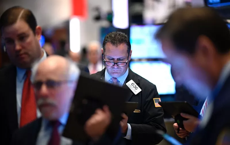 Traders work during the opening bell at the New York Stock Exchange (NYSE) on November 4, 2019 at Wall Street in New York City. - Wall Street stocks added to records early Monday, boosted by optimism over US-China trade talks, while McDonald's retreated on an executive shakeup. Analysts cited remarks from US Commerce Secretary Wilbur Ross that "phase one" of the trade agreement between Beijing and Washington was on track."The news seems to be getting good," J.J. Kinahan, chief market strategist at TD Ameritrade, said of the trade developments. (Photo by Johannes EISELE / AFP)