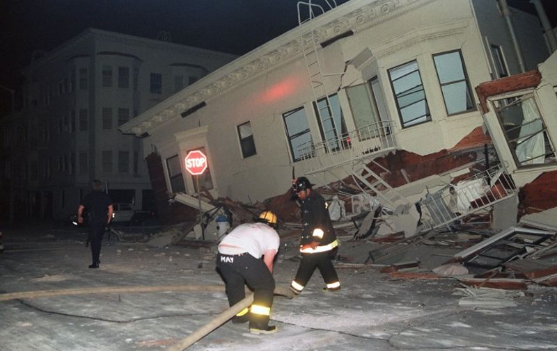 Firemen search for occupants in a heavily-damaged building in the Marina District of San Francisco, one of the areas hardest hit in the city by an earthquake estimated at 7.0 on October 17, 1989.