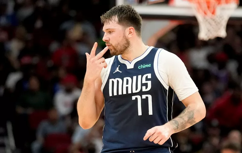 Dallas Mavericks guard Luka Doncic gestures after making a 3-point basket against the Houston Rockets during the first half of an NBA basketball game Sunday, March 31, 2024, in Houston. (AP Photo/Eric Christian Smith)