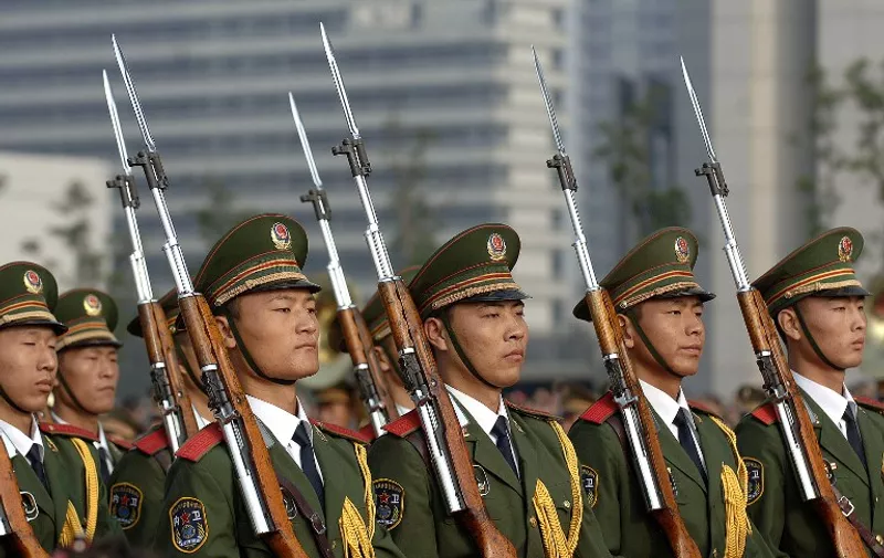 Chinese paramilitary guards march during a flag-raising ceremony in Hefei in central China's Anhui province, 01 October 2007, to mark China's National Day.  Millions of Chinese throughout the country gather on city squares to celebrate the 58th anniversary of the founding of the People's Republic of China.          CHINA OUT GETTY OUT       AFP PHOTO