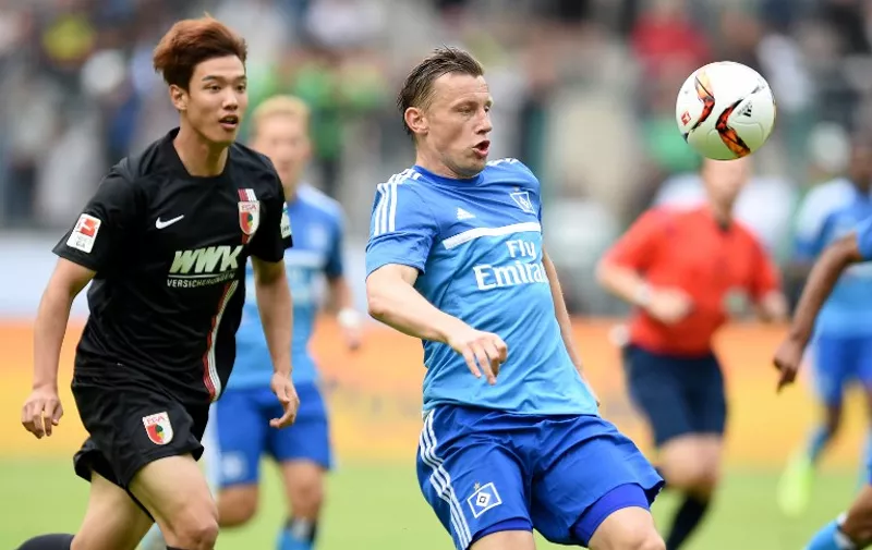 Hamburg's midfielder Ivica Olic and Augsburg's South Korean defender Jeong-Ho Hong vie for the ball during the German Telkom Cup 2015 final football match FC Augsburg and Hamburger SV in Moenchengladbach, western Germany on July 12, 2015. AFP PHOTO / PATRIK STOLLARZ

DFL RULES TO LIMIT THE ONLINE USAGE DURING MATCH TIME TO 15 PICTURES PER MATCH. IMAGE SEQUENCES TO SIMULATE VIDEO IS NOT ALLOWED AT ANY TIME. FOR FURTHER QUERIES PLEASE CONTACT DFL DIRECTLY AT + 49 69 650050.