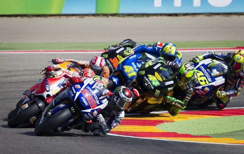 Yamaha Team's Spanish rider Jorge Lorenzo leads the pack in the first curve during the Moto GP race of the Aragon Grand Prix at the Motorland racetrack in Alcaniz on September 27, 2015. AFP PHOTO/ JAIME REINA