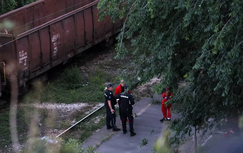 Police and ambulance officers stand at the site where two trains collided in Belgrade, on May 17, 2024. Nine people were injured on Friday when a goods convoy collided with a passenger train in a tunnel in Belgrade. (Photo by OLIVER BUNIC / AFP)
