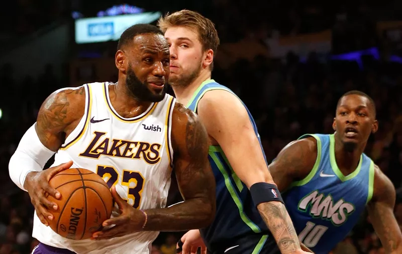 LOS ANGELES, CALIFORNIA - DECEMBER 01: LeBron James #23 of the Los Angeles Lakers drives toward the hoop as Luka Doncic #77 of the Dallas Mavericks defends during the second half at Staples Center on December 01, 2019 in Los Angeles, California. NOTE TO USER: User expressly acknowledges and agrees that, by downloading and or using this photograph, User is consenting to the terms and conditions of the Getty Images License Agreement. (Photo by Katharine Lotze/Getty Images)