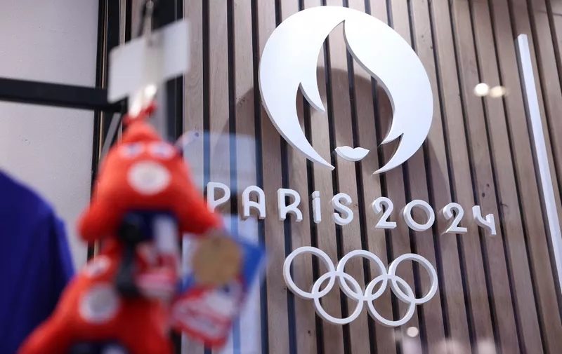 This photograph taken on November 15, 2022, in Paris, shows the Paris 2024 Olympic and Paralympic Games official logo, displayed in the official Paris 2024 shop in Les Halles shopping mall in central Paris. - The Olympic and Paralympic mascots are named "Les Phryges" and represent French revolutionary Phrygian caps. (Photo by Thomas SAMSON / AFP)