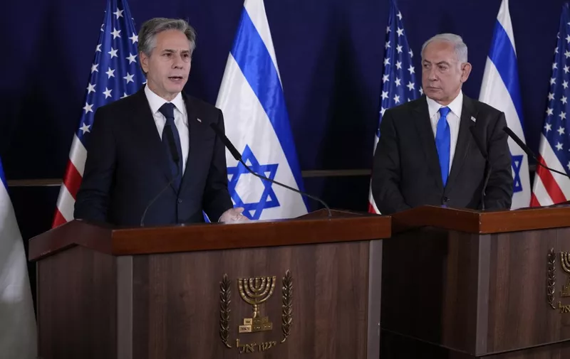 Israeli Prime Minister Benjamin Netanyahu (R) looks on as US Secretary of State Antony Blinken gives statements to the media inside The Kirya, which houses the Israeli Defence Ministry, after their meeting in Tel Aviv on October 12, 2023. Blinken arrived in a show of solidarity after Hamas's surprise weekend onslaught in Israel, an AFP correspondent travelling with him reported. He is expected to visit Israeli Prime Minister Benjamin Netanyahu as Washington closes ranks with its ally that has launched a withering air campaign against Hamas militants in the Gaza Strip. (Photo by Jacquelyn Martin / POOL / AFP)