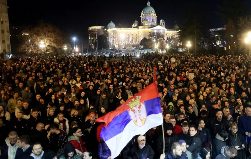 Protesters gather in front of Belgrade's city council building during a demonstration in Belgrade, on December 24, 2023, a week after the parliamentary and local elections in Serbia. Serbia announced plans on December 20, to rerun elections in 30 polling locations, according to state media, just days after nationwide parliamentary and local elections triggered protests and international condemnation over alleged fraud.  "The Serbian electoral commission decided that parliamentary elections in Serbia will be repeated at 30 polling stations and will be held on December 30," said a statement published by state-run broadcaster RTS. (Photo by OLIVER BUNIC / AFP)