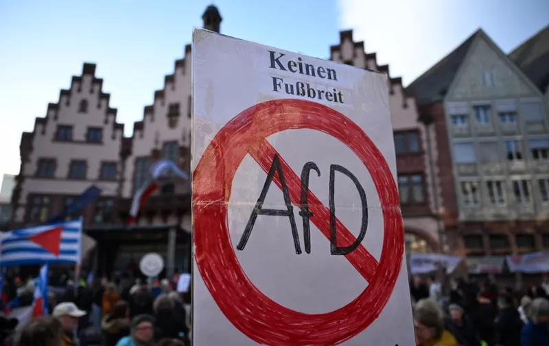 A sign reading "not yield an inch for AfD (Alternative für Deutschland)" is held during a demonstration against racism and far-right politics on February 5, 2024, in Frankfurt am Main. (Photo by Kirill KUDRYAVTSEV / AFP)