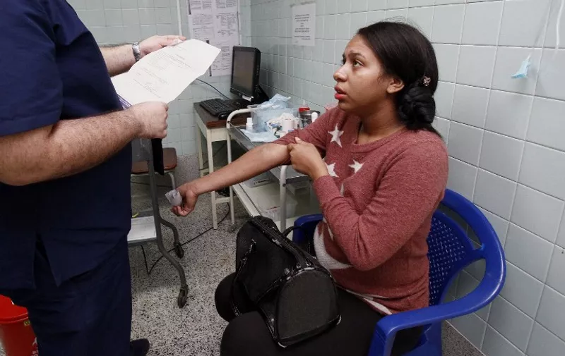 Pregnant woman Angelica Prato, infected by the Zika virus, is attended at the Erasmo Meoz University Hospital in Cucuta, Colombia, on January 25, 2016. Authorities in Brazil, Colombia, Ecuador, El Salvador and Jamaica have advised couples to avoid pregnancy for the time being due to the presence of the Zika virus because if a pregnant woman is infected by the virus, the baby could be born with microcephaly. The Zika virus, a mosquito-borne disease suspected of causing serious birth defects, is expected to spread to all countries in the Americas except Canada and Chile, the World Health Organization said. AFP PHOTO/Schneyder Mendoza / AFP / SCHNEYDER MENDOZA