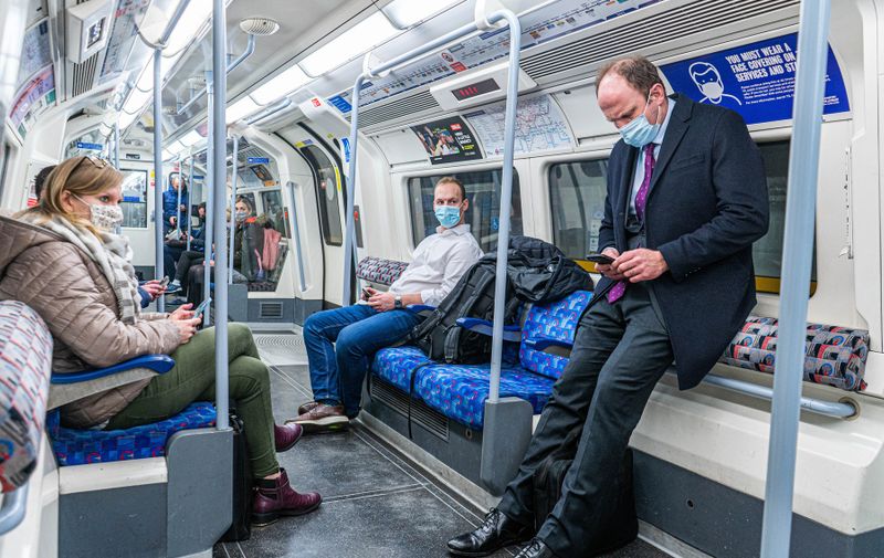 Commuters on the London underground wearing facmasks  as Prime Minister Boris Johnson announces tougher covid restrictions  including Work from home, wearing masks and introducing Covid passes to combat the  exponential rise of the omicron variant in light of the Christmas party scandal at Downing Street
Government announces new covid measures, Westminster, London, UK - 09 Dec 2021,Image: 647124888, License: Rights-managed, Restrictions: , Model Release: no, Credit line: Profimedia