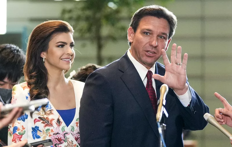 Florida Governor Ron DeSantis (R) waves to journalists as his wife Casey (L) looks one after meeting Japanese Prime Minister Fumio Kishida at the latter's official residence in Tokyo on April 24, 2023. (Photo by Kimimasa MAYAMA / POOL / AFP)