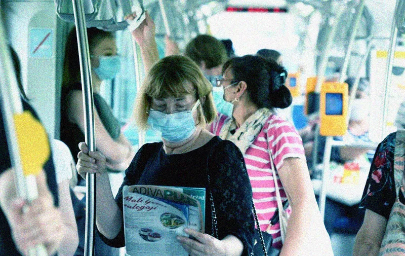 Passengers travel wearing facemasks on a tram in Zagreb on June 25, 2020, as the wearing of masks on public transport in Croatia became mandatory on June 23, due to an increase of coronavirus infections after the relaxation of lockdown conditions. (Photo by DENIS LOVROVIC / AFP)